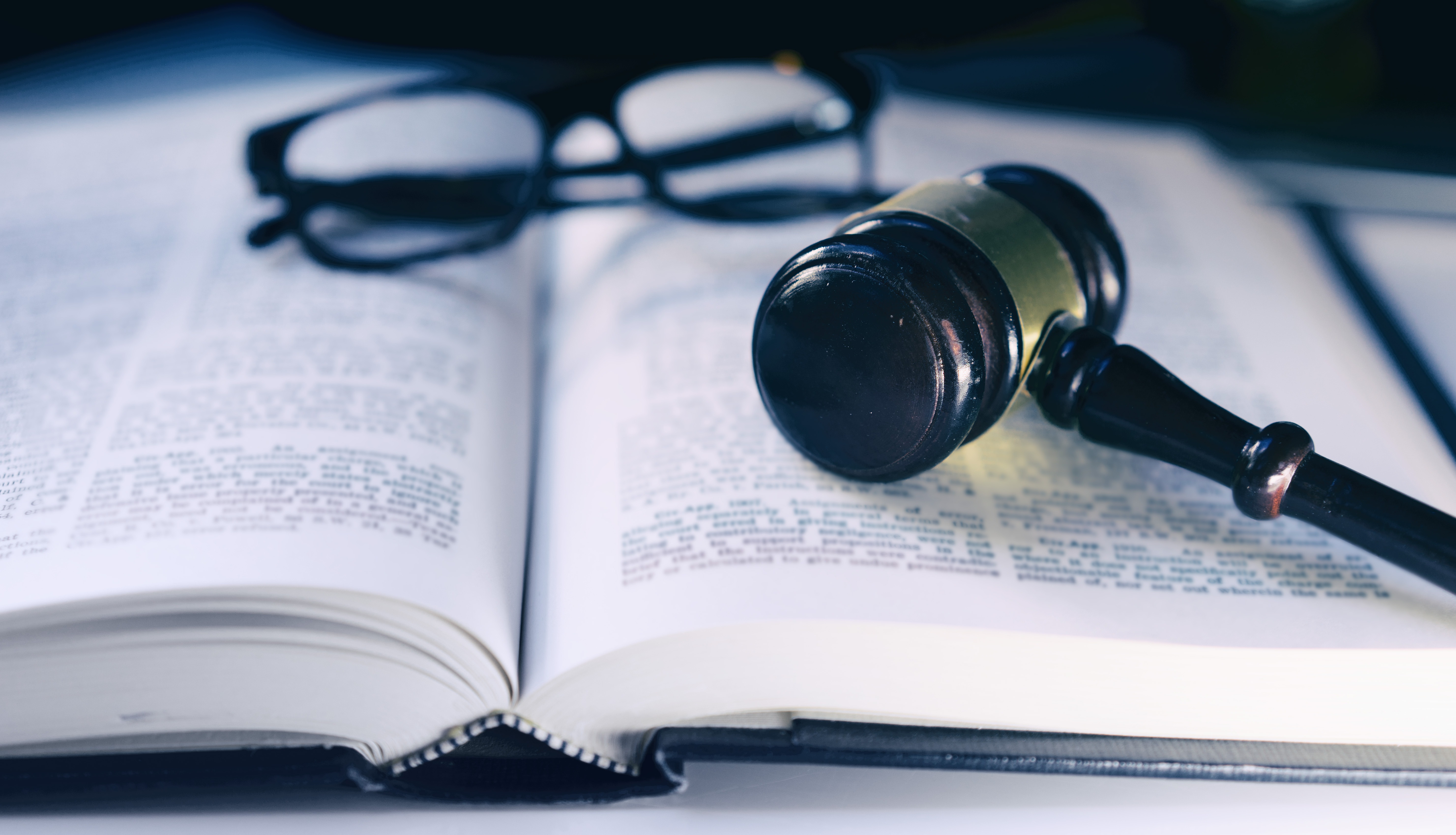 Legal reference materials, reading glasses, and a judge’s gavel