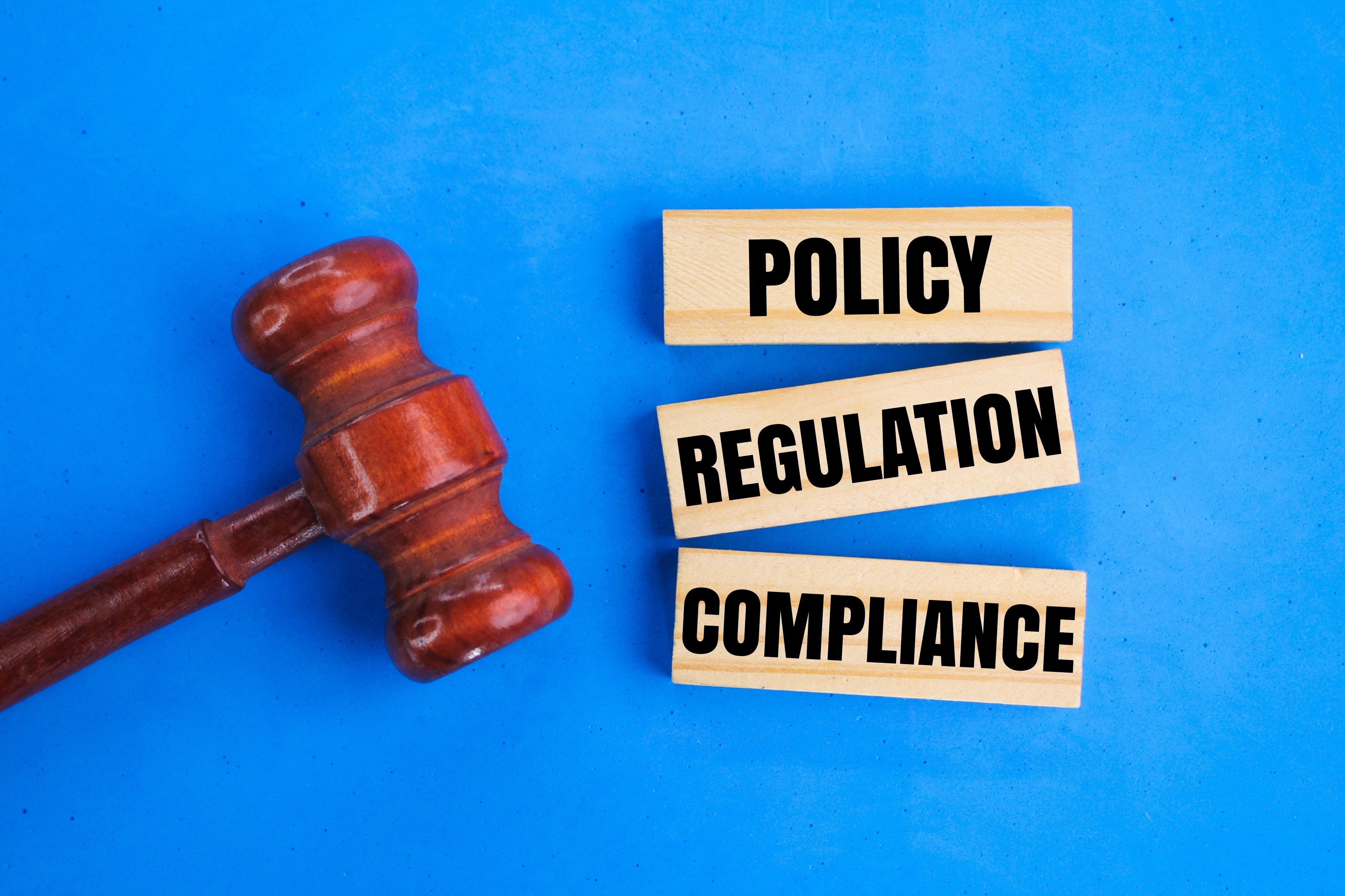 Legal gavel with policy, regulation, and compliance themes